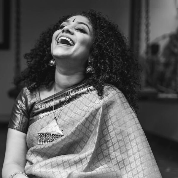 Indian classical crossover singer Roopa Mahadevan smiling and laughing with head tilted back