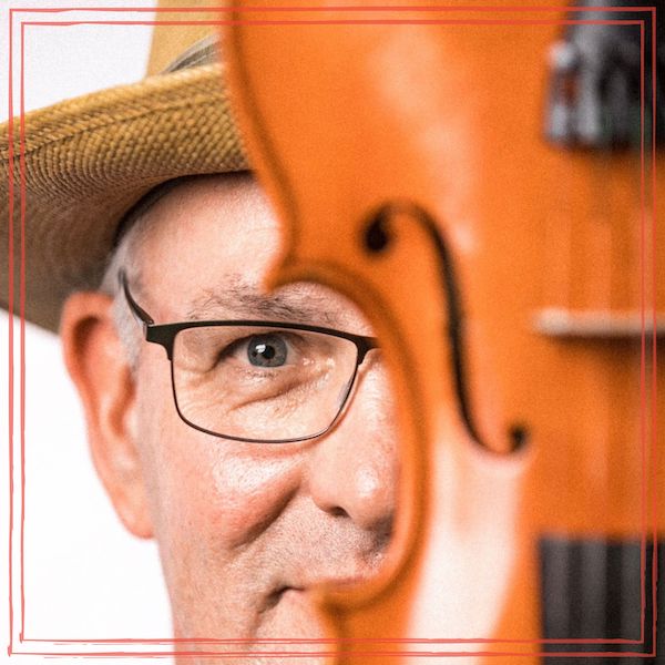 Fiddle Joe Patterson headshot behind violin | Photo by @marquezivan in Instagram | https://www.instagram.com/marquezivan/