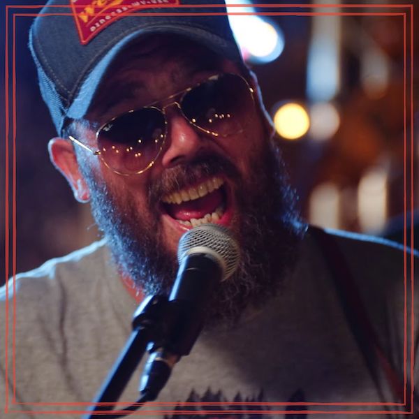 Tony Harrah singing with sunglasses and ball cap. | Image courtesy of Mountain Craft Productions www.mtncraft.com